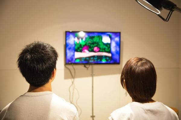 unrecognizable young couple playing video game at home