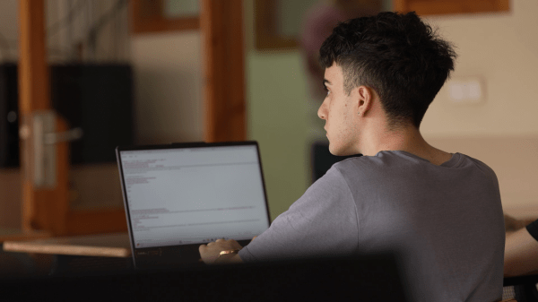 Eric Tello attending a class with his laptop