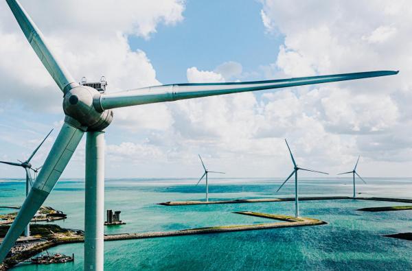 Offshore wind farm with several turbines generating renewable energy.